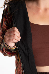 Emily is wearing the Orange Pahadi Patchwork Jacket in S/M