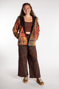 Emily is wearing the Orange Pahadi Patchwork Jacket in S/M