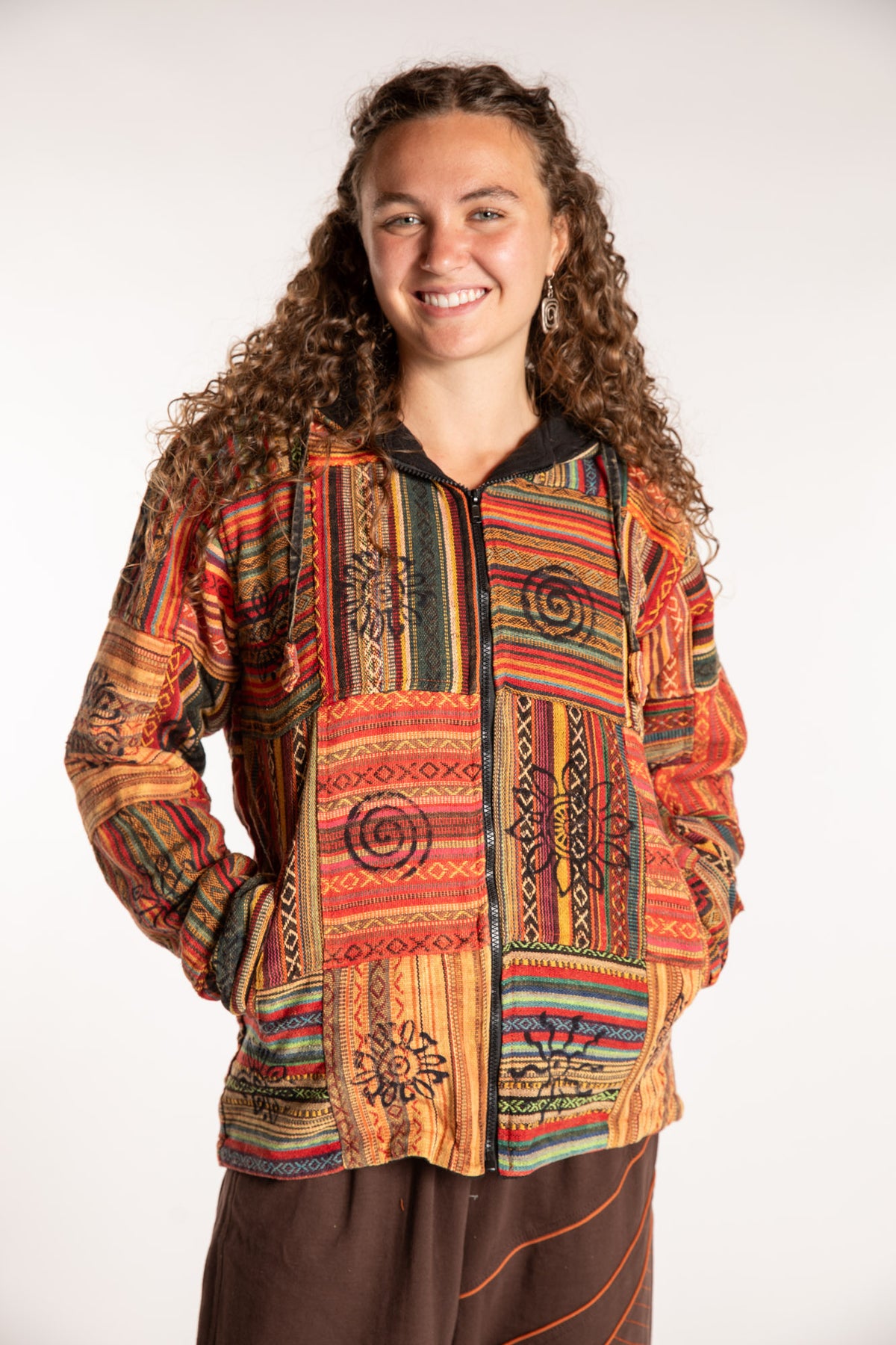Emily is wearing the Orange Pahadi Patchwork Jacket in S/M