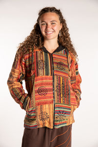Emily is wearing the Orange Pahadi Patchwork Jacket in S/M