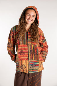 Emily is wearing the Orange Pahadi Patchwork Jacket in S/M