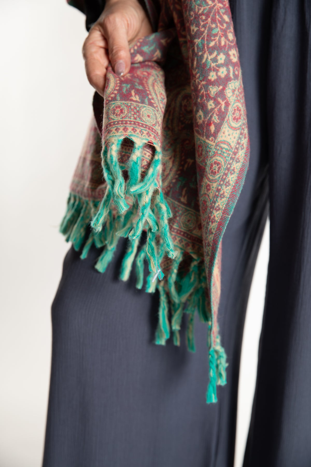 The tasseled edge of the Paisley Soft Brushed Shawl in Rose