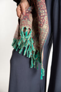 The tasseled edge of the Paisley Soft Brushed Shawl in Rose