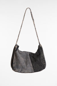 A black patchwork petals shoulder bag with a braided strap