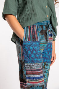 Emily is wearing the Blue Patchwork Stone Wash Meditation Pants in Small