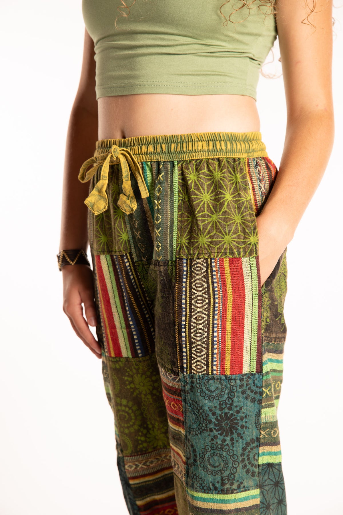 Emily is wearing the Green Patchwork Stone Wash Meditation Pants in Small