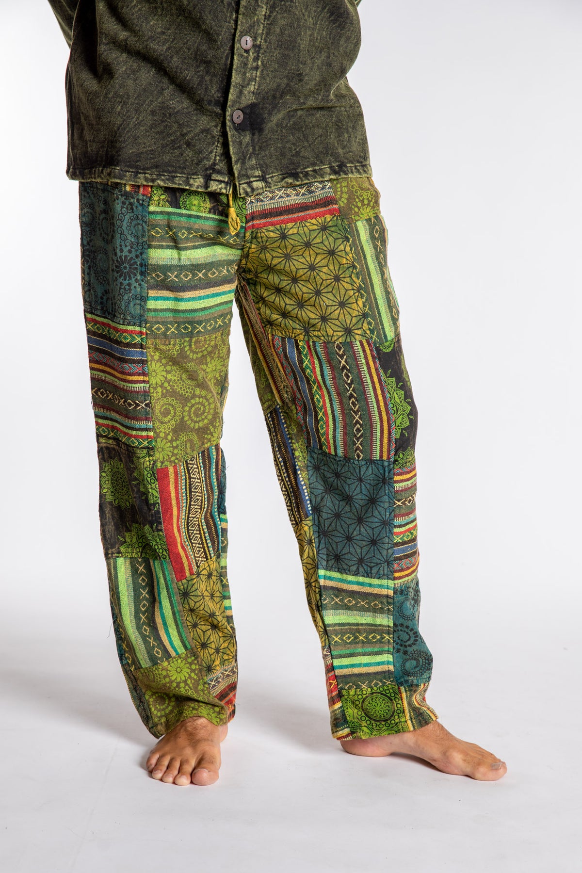 Topher is wearing the Green Patchwork Stone Wash Meditation Pants in XL