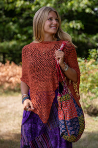Sophie is carrying the  Recycled Kantha Patchwork Beach Bag and wearing the Jaya Patchwork Utility Skirt and the Asymmetrical Loose Weave Poncho. 