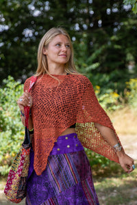 Sophie is carrying the  Recycled Kantha Patchwork Beach Bag and wearing the Jaya Patchwork Utility Skirt and the Asymmetrical Loose Weave Poncho. 