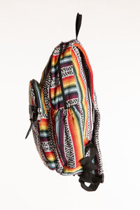 Side view of colorful striped cotton backpack with black trim and side pocket
