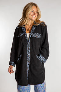 Sophie is wearing the S/M Priya Sari Patch Fleece Jacket in Black 