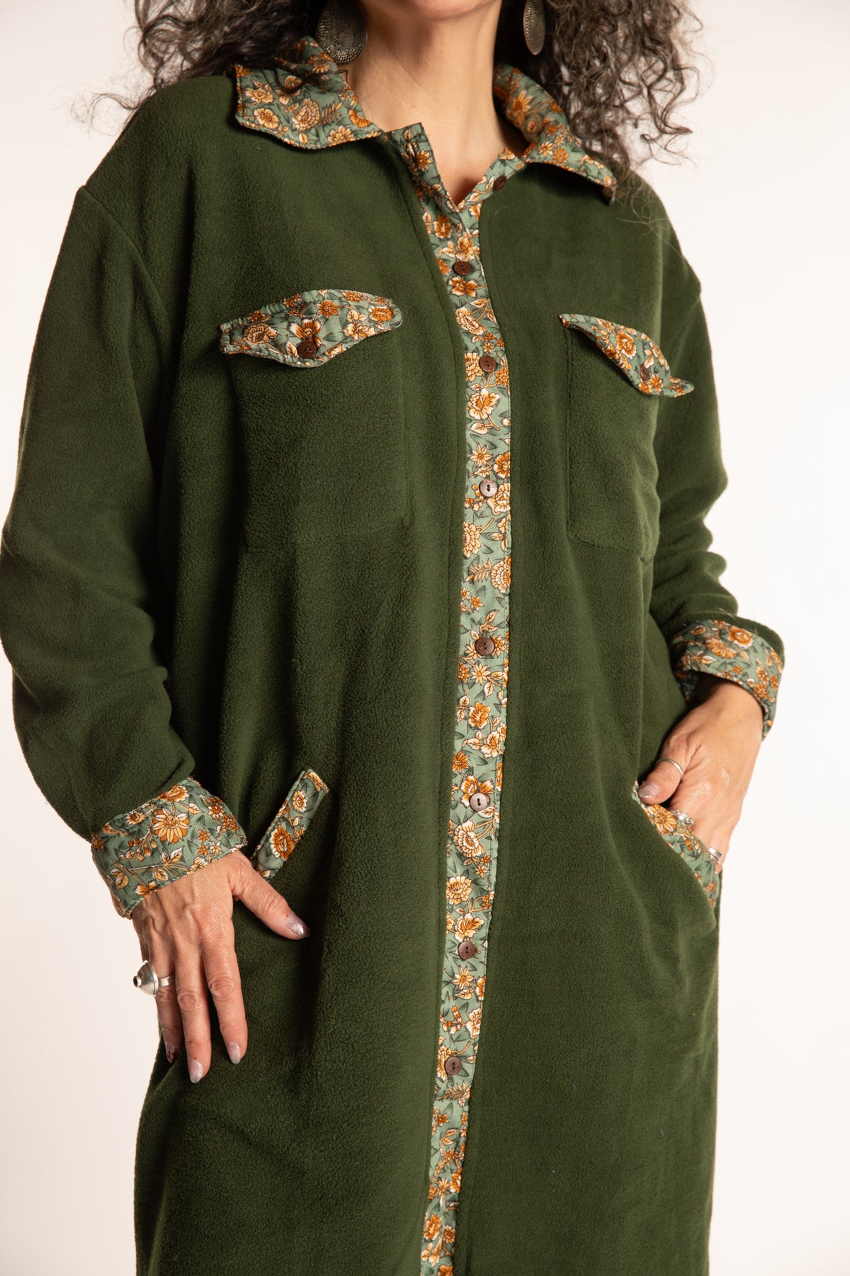 Susan is wearing the M/L Priya Patch Fleece Jacket in Green