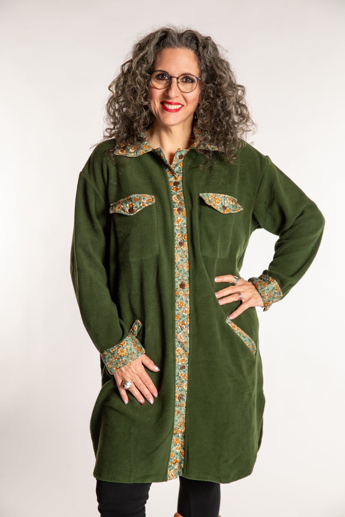 Susan is wearing the M/L Priya Patch Fleece Jacket in Green