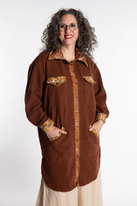 Susan is wearing the M/L Priya Patch Fleece Jacket in Rust