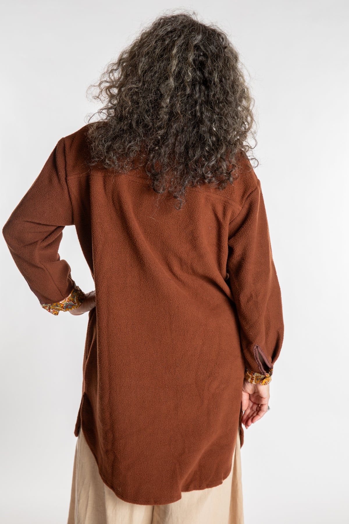 Susan is wearing the M/L Priya Patch Fleece Jacket in Rust