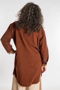 Susan is wearing the M/L Priya Patch Fleece Jacket in Rust