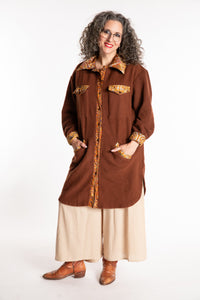 Susan is wearing the M/L Priya Patch Fleece Jacket in Rust
