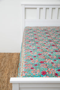 Bohemian block print tapestry in Bittersweet Brambles, displayed as a bedspread