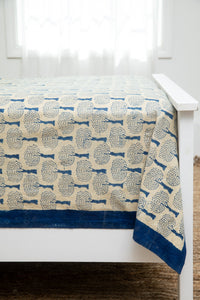Bohemian block print tapestry in Blue and Tan Tree, displayed as a bedspread