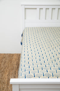 Bohemian block print tapestry in Blue and Tan Tree, displayed as a bedspread