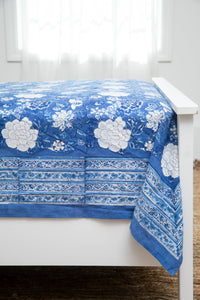 Bohemian block print tapestry in Blue Tropical Floral, displayed as a bedspread