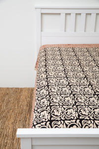 Bohemian block print tapestry in Crepuscular Vines, displayed as a bedspread