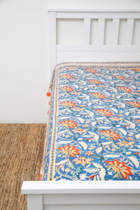 Bohemian block print tapestry in Electric Lilyland, displayed as a bedspread