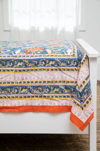 Bohemian block print tapestry in Electric Lilyland, displayed as a bedspread
