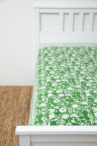 Bohemian block print tapestry in Forest Peonies, displayed as a bedspread