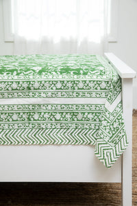 Bohemian block print tapestry in Forest Peonies, displayed as a bedspread