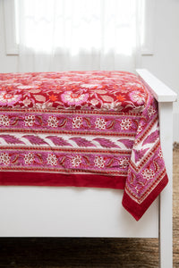 Bohemian block print tapestry in Garnet Profusion, displayed as a bedspread