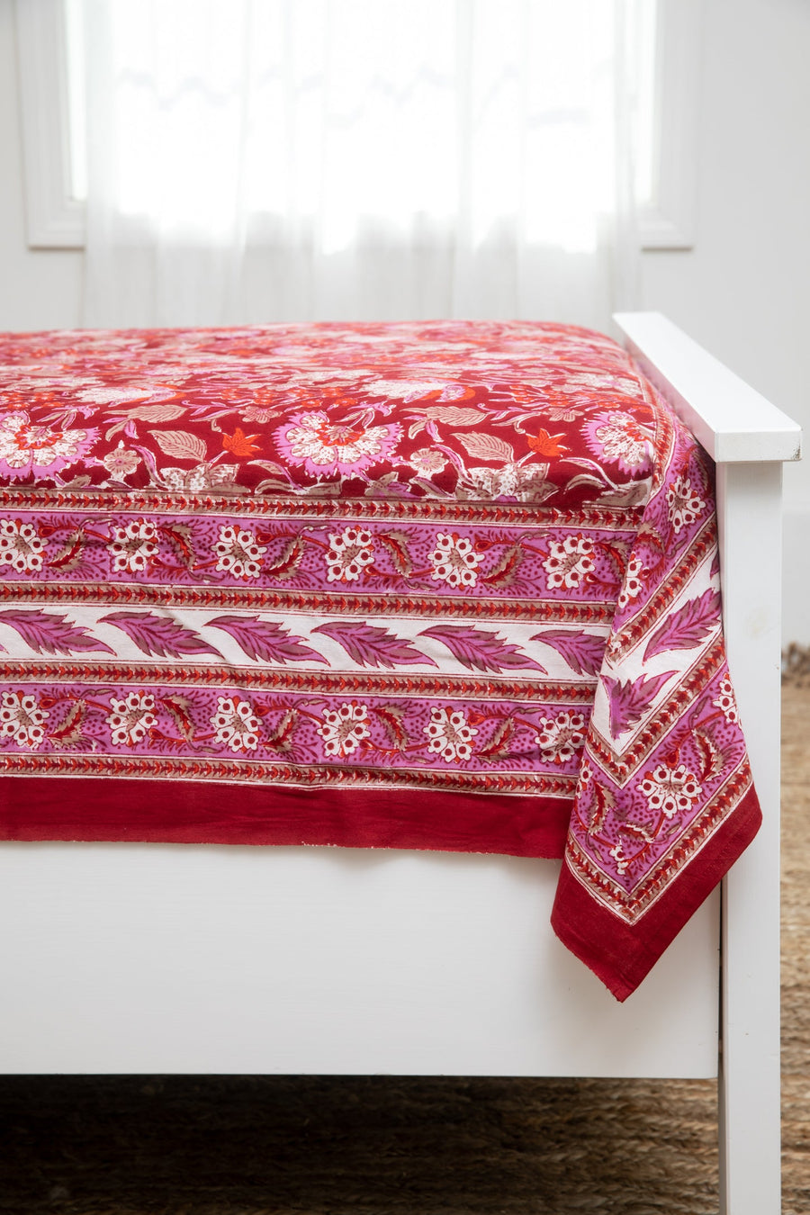 Bohemian block print tapestry in Garnet Profusion, displayed as a bedspread