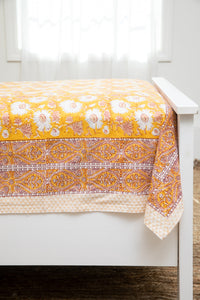 Bohemian block print tapestry in Halcyon Daydream, displayed as a bedspread
