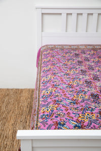 Bohemian block print tapestry in Lavender Lush, displayed as a bedspread