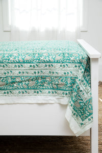 Bohemian block print tapestry in Teal Treasures, displayed as a bedspread