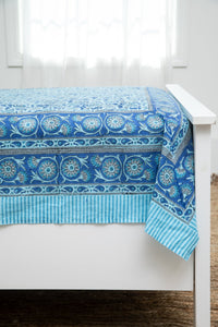 Bohemian block print tapestry in Turquoise Thistle, displayed as a bedspread