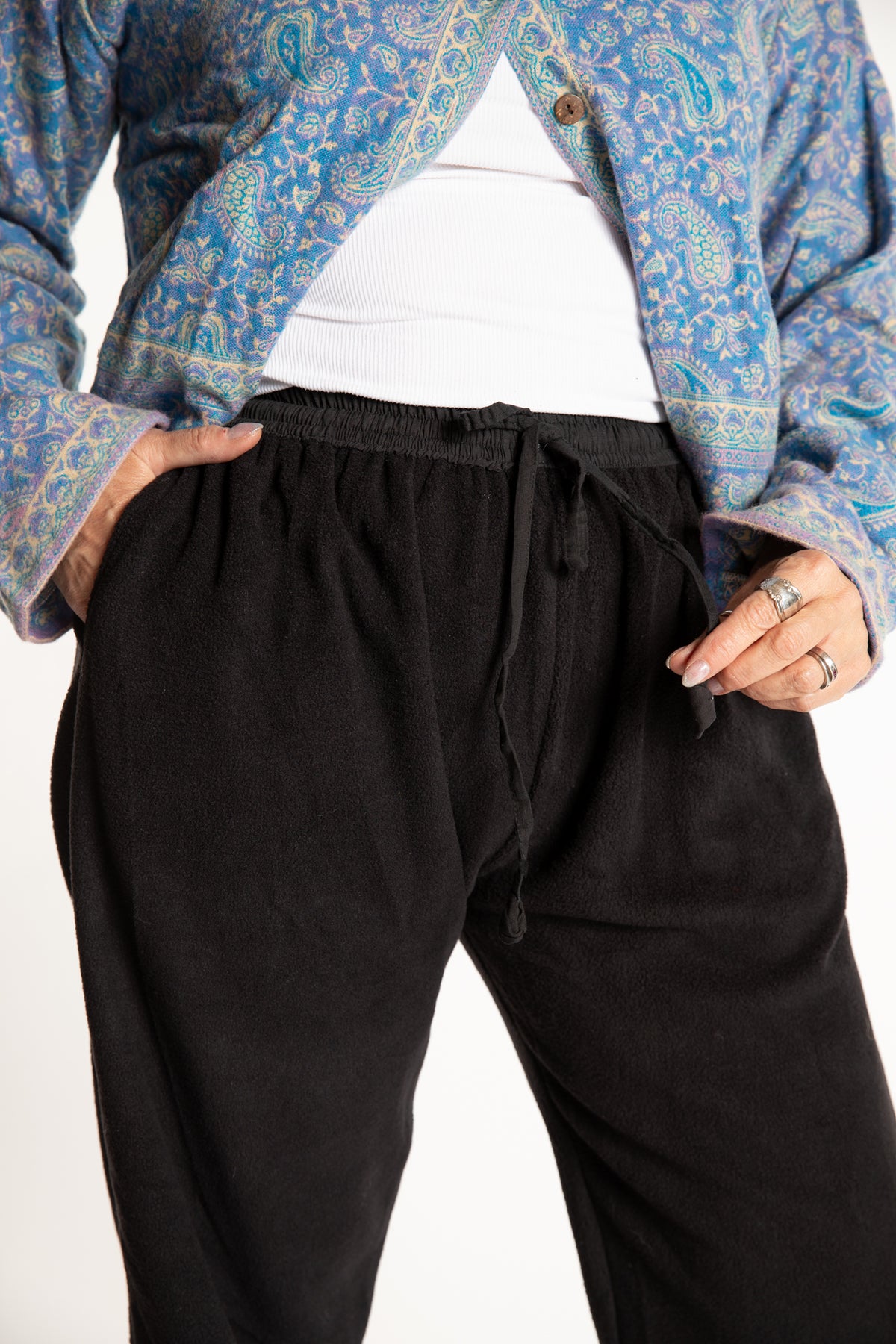 Susan is wearing the L/XL Ravi Sari Patch Fleece Pants in Black