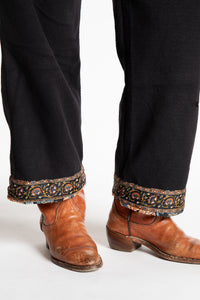 Susan is wearing the L/XL Ravi Sari Patch Fleece Pants in Black