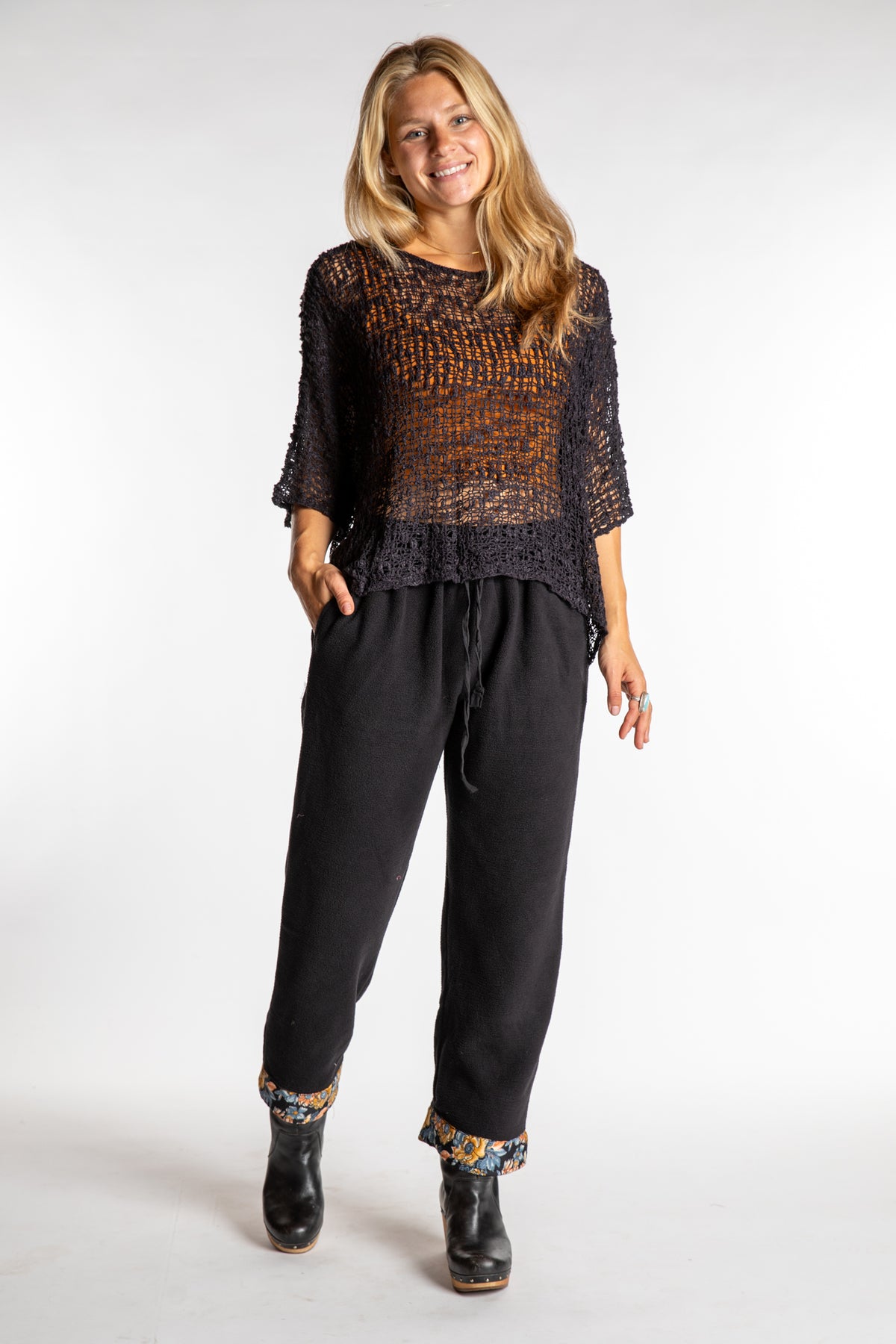 Sophie is wearing the S/M Ravi Sari Patch Fleece Pants in Black