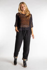 Sophie is wearing the S/M Ravi Sari Patch Fleece Pants in Black