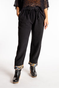 Sophie is wearing the S/M Ravi Sari Patch Fleece Pants in Black