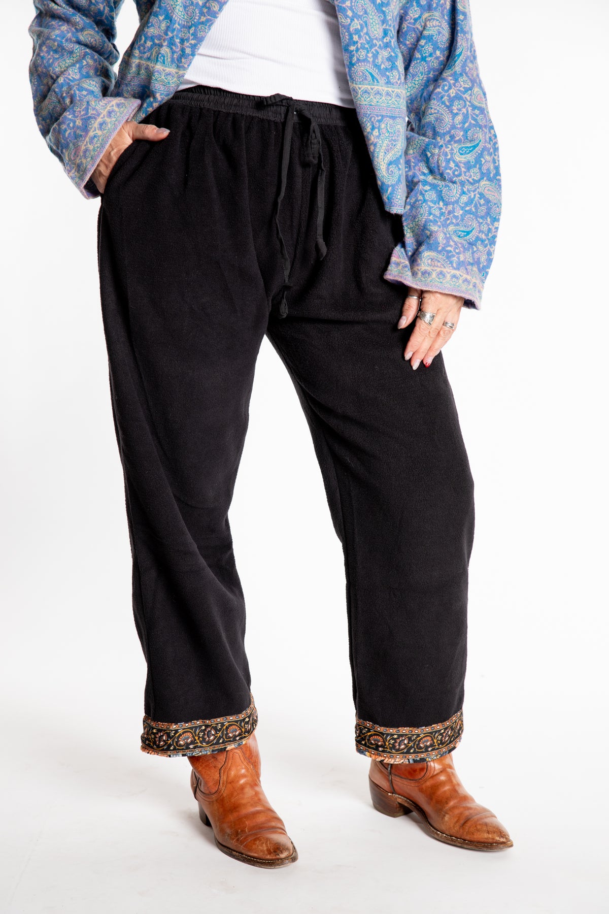 Susan is wearing the L/XL Ravi Sari Patch Fleece Pants in Black