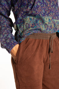 Sophie is wearing the S/M Ravi Sari Patch Fleece Pants in Brown