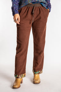 Sophie is wearing the S/M Ravi Sari Patch Fleece Pants in Brown