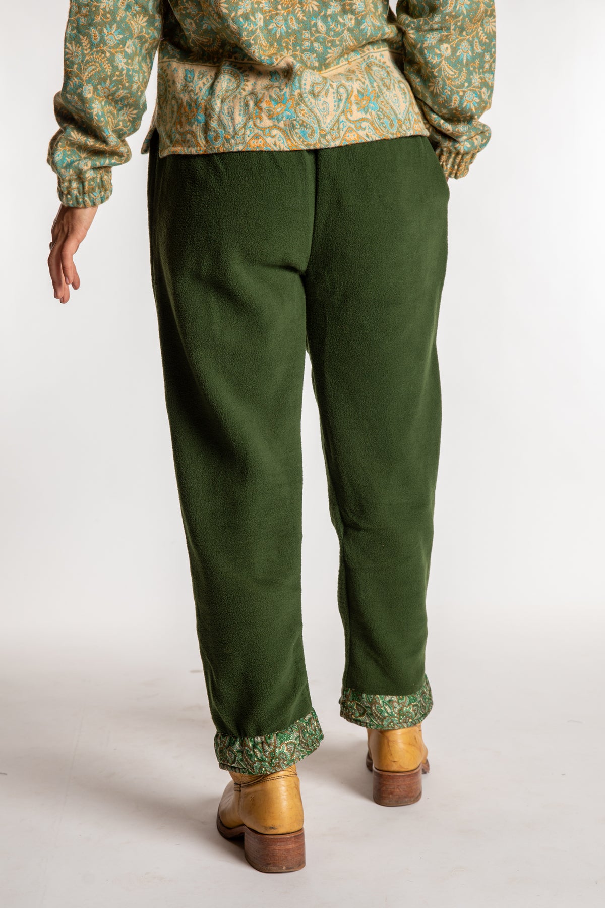 Sophie is wearing the S/M Ravi Sari Patch Fleece Pants in Green