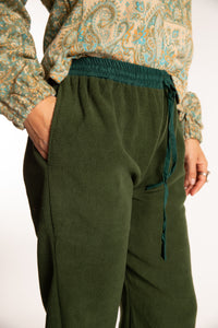 Sophie is wearing the S/M Ravi Sari Patch Fleece Pants in Green
