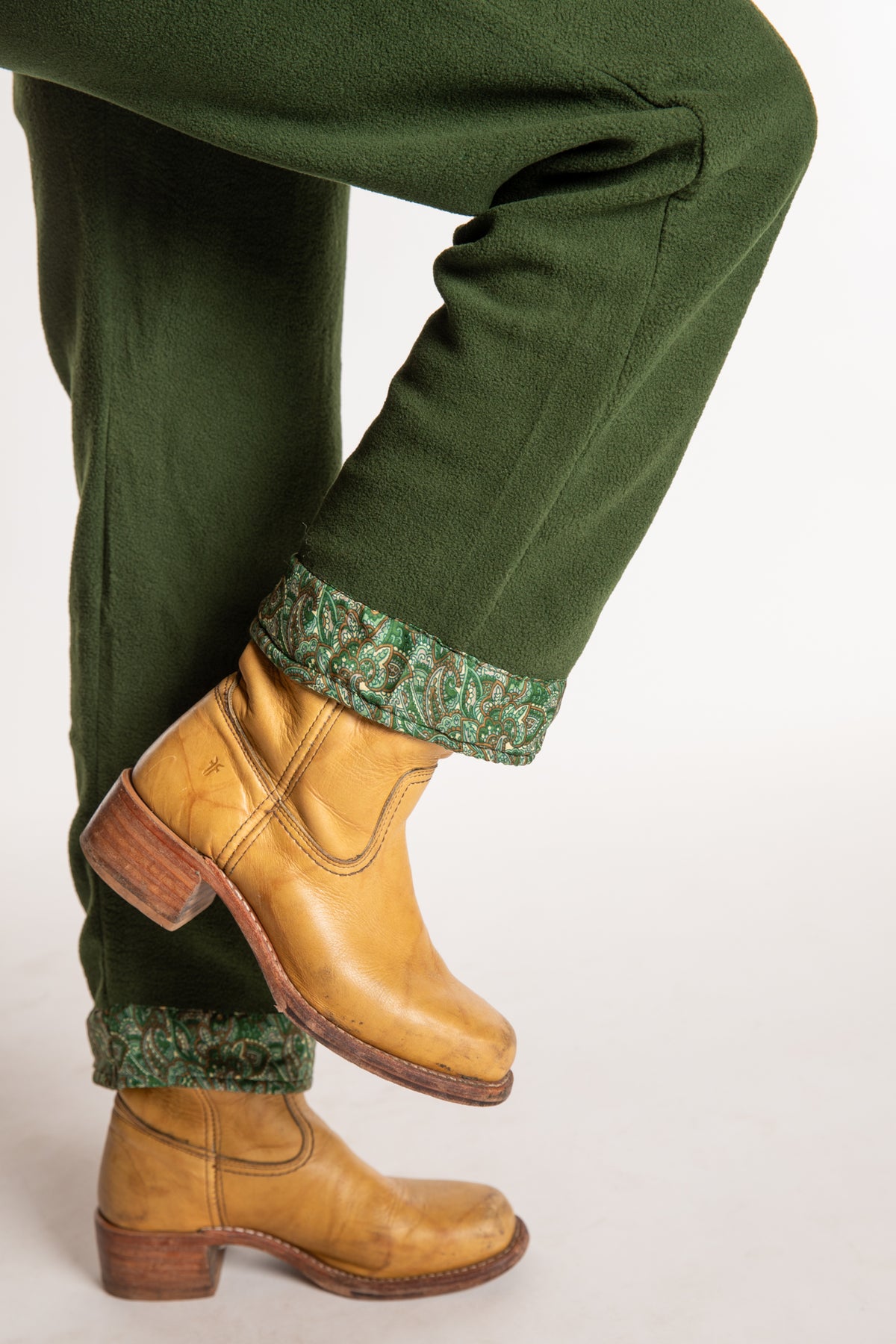 Sophie is wearing the S/M Ravi Sari Patch Fleece Pants in Green