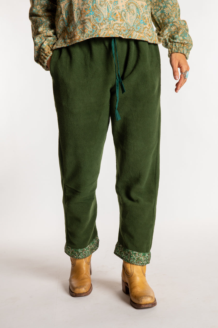 Sophie is wearing the S/M Ravi Sari Patch Fleece Pants in Green