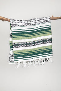 Striped recycled blanket with green, white, and black pattern on a white background