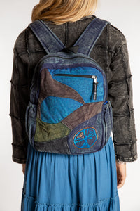 Sophie wearing blue patchwork cotton backpack with contrasting patterned fabric panels